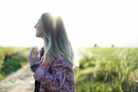 selective focus photo of woman wearing pink and gray floral jacket thumbnail