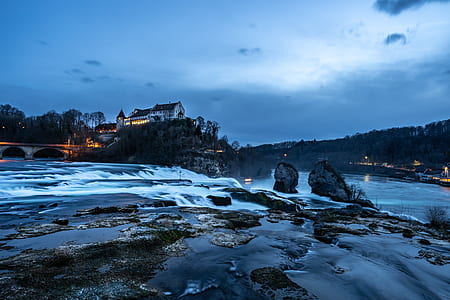white house over the cliff near river thumbnail