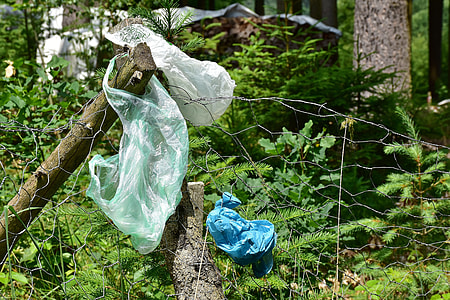 three plastic bags hanged on fence thumbnail