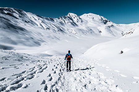 person snow skiing beside mountain during day time thumbnail