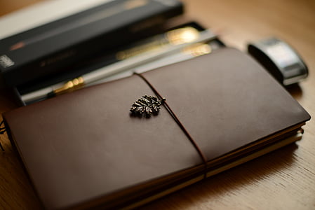 selective focus photography of brown planner thumbnail