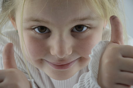shallow focus photography of a girl wearing white shirt thumbnail