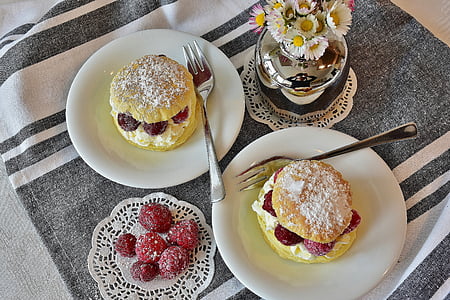 two white ceramic plates with dessert on top thumbnail