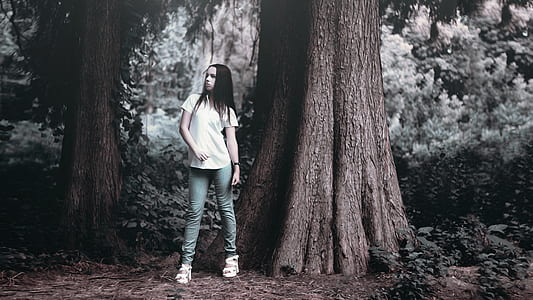woman in shirt beside tree thumbnail
