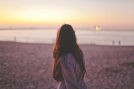 woman wearing gray long-sleeved shirt during sunset thumbnail