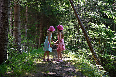 girls in pink and blue sleeveless dress holding hands thumbnail