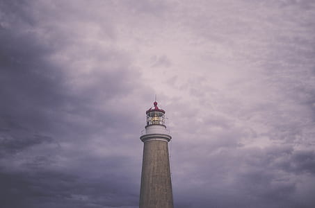 gray concrete lighthouse under white cloudy sky thumbnail