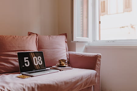 Workplace with a laptop on a pink couch thumbnail