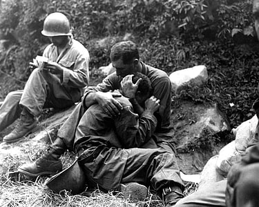 G.I. comforting a grieving infantryman in Korean War thumbnail