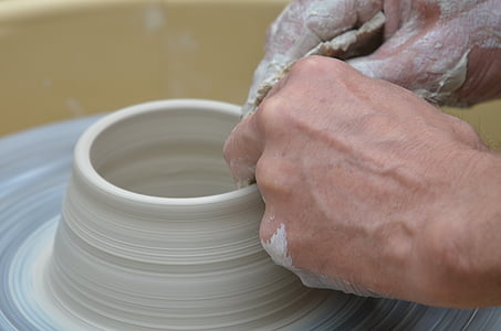 person making clay pot thumbnail