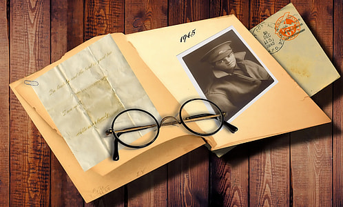round black framed eyeglasses on book photo thumbnail