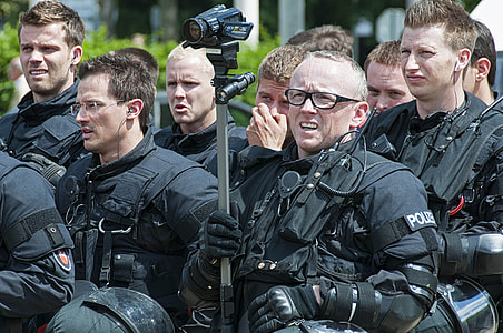 group of policemen gathered standing near building during daytime thumbnail