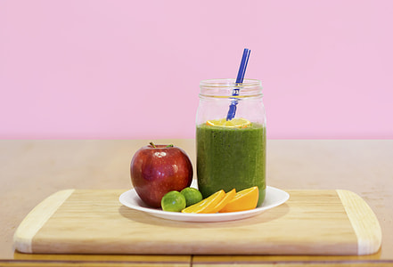 green liquid on drinking glass with assorted fruits on the plate thumbnail