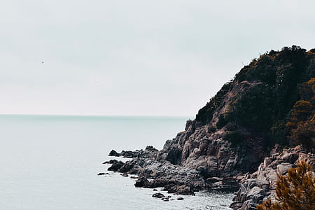 body of water near rocky mountain thumbnail