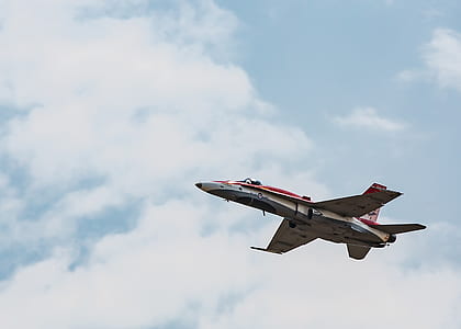 white and red plane in mid air at daytime thumbnail