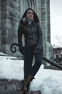 woman wearing black leather zip-up jacket sitting on handrail thumbnail