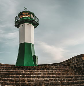 White and Green Lighthouse Under Gray Clouds thumbnail