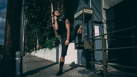 man with foot on payphone thumbnail