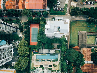 bird's eye view photo of tennis court near residential building thumbnail