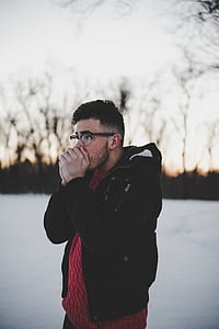 man wears black jacket covers his mouth thumbnail