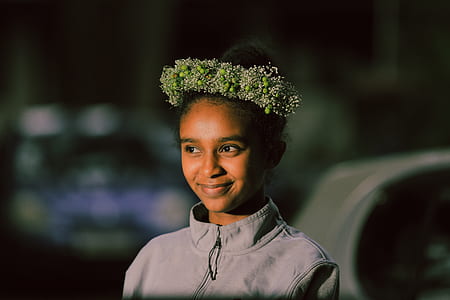 smiling woman wearing floral headdress thumbnail