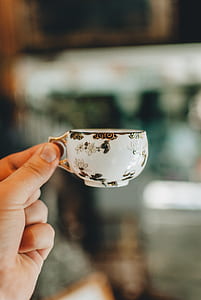 person holding teacup thumbnail