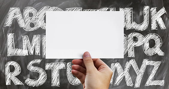 person holding black piece od paper thumbnail