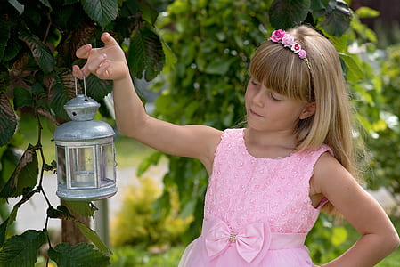 girl carrying tubular candle thumbnail