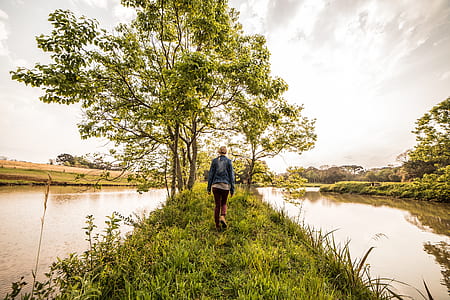 person walking along river thumbnail