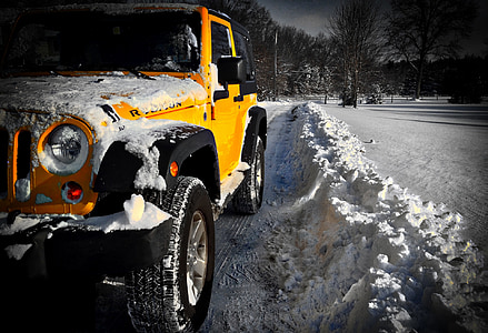 yellow Jeep Rubicon on road with snow thumbnail