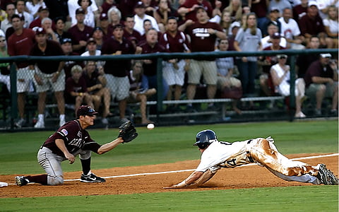 white wearing blue helmet diving in front of man catching baseball ball thumbnail