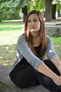 woman sitting on concrete fence thumbnail