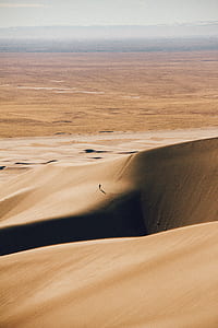 man walking in the middle of desert thumbnail
