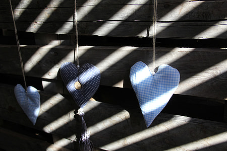 three heart hanging beside gray wooden planks thumbnail