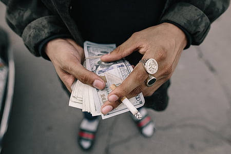 person holding US dollar banknotes thumbnail