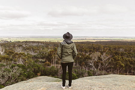person facing backwards near cliff thumbnail