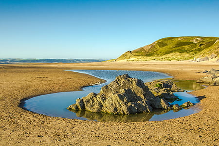 rock formation on body of water thumbnail