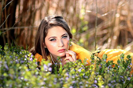 shallow focus photography of woman lying on grass thumbnail