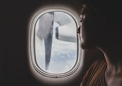 woman looking outside airliner window thumbnail