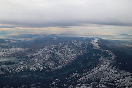 aerial photography of river between mountains under gray cloudy sky at daytime thumbnail