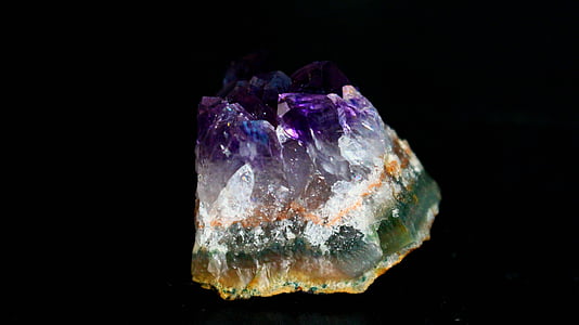 green, white, and purple stone with black background thumbnail