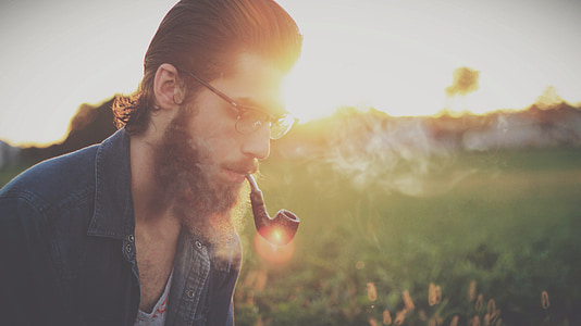 selective focus photography of man using smoking pipe thumbnail