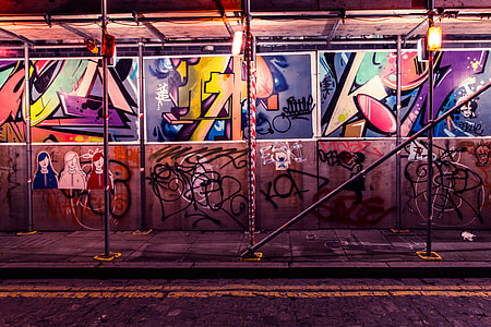 Street art and graffiti by building scaffold in Shoreditch, East London thumbnail