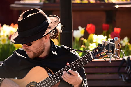 man wearing black cap paying brown acoustic guitar thumbnail