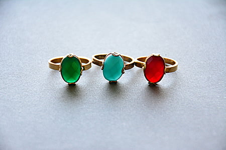 three gold-colored rings with three assorted-color gemstones thumbnail