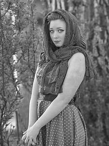 grayscale photo of woman in floral scarf and polka-dot sleeveless dress thumbnail
