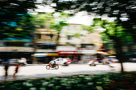 photo of motorcycle running on road near building thumbnail
