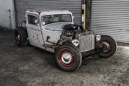 vintage gray and white coupe near gray door shutter thumbnail