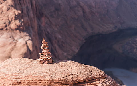 balanced stone on brown rock formation thumbnail