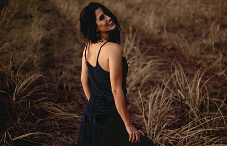 woman standing on grass while smiling thumbnail